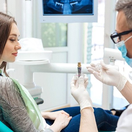 Patient in Greensboro talking to dentist about a dental implant