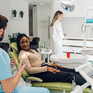 Patient in Greensboro talking to dentist about a dental implant