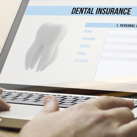 Person filling out dental insurance form on laptop
