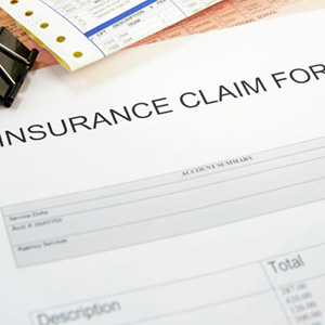 Close-up of insurance claim form with other documents