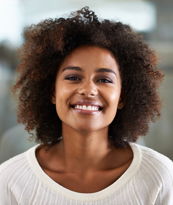 Woman smiling after teeth whitening in Greensboro