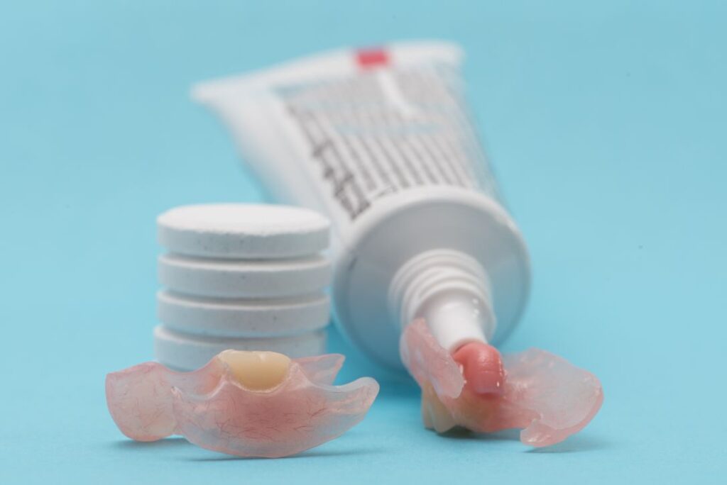 Dentures and denture adhesive
